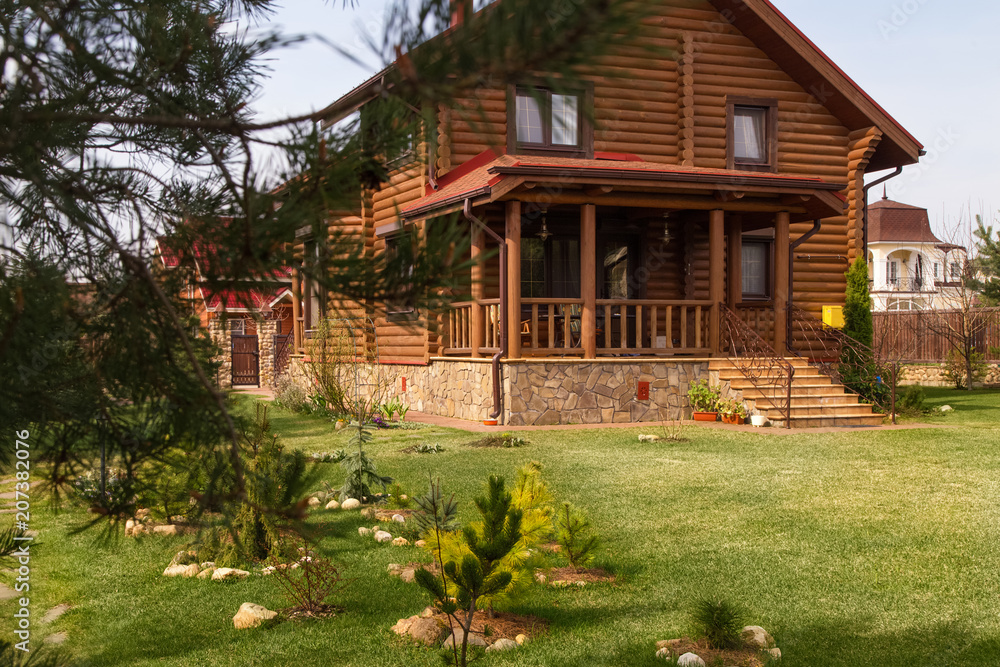 Wooden House. Pine Trees.Green Grass