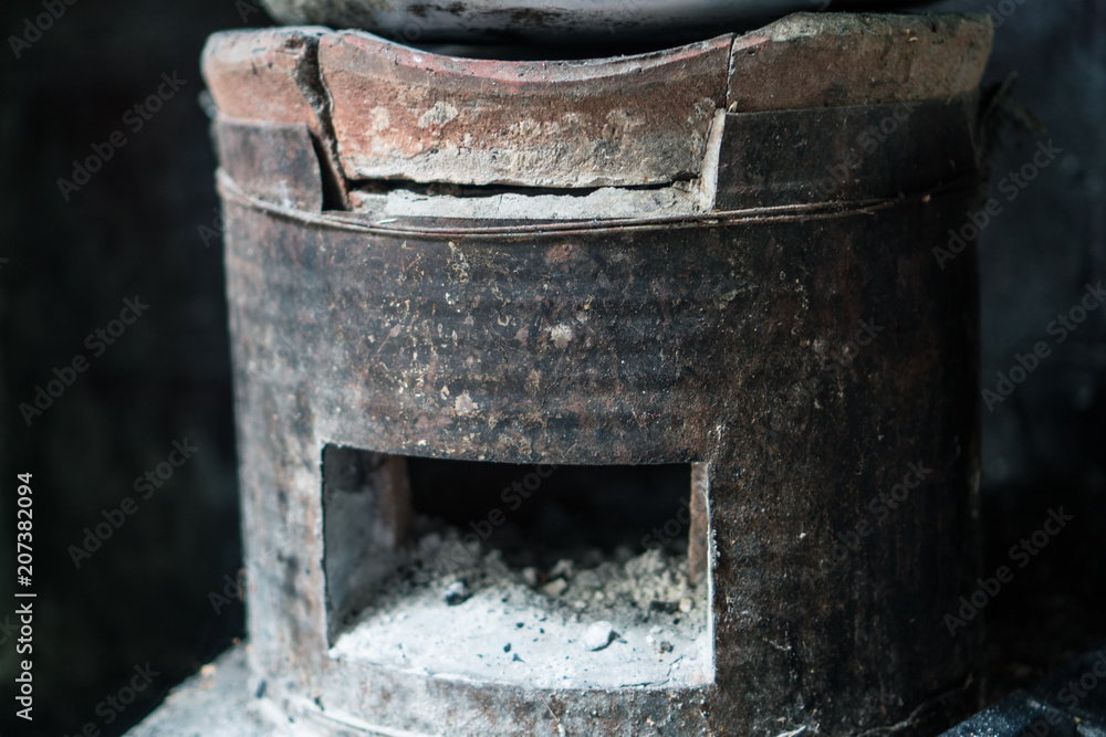 Thai stove style use for cooking, heating by burn black carbon charcoal on the top of stove and flow the wind into the bottom. Classical method in Thailand kitchen. Thai stove style use for cooking, heating by burn black carbon charcoal on the top of stove and flow the wind into the bottom. Classical method in Thailand kitchen.