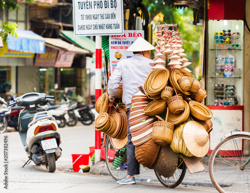 HANOI, VIETNAM - DECEMBER 16, 2016: The seller of wicker baskets in the local market. Copy space for text.