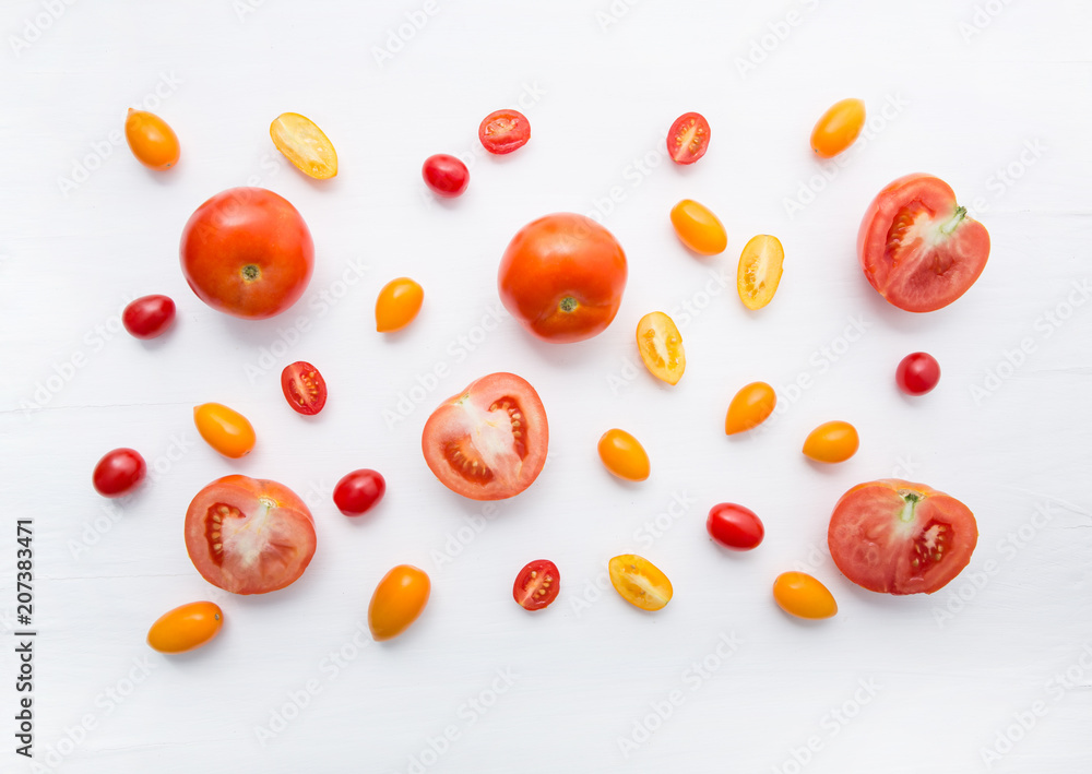 variety tomatoes on white wooden background. variety tomatoes on white wooden background.