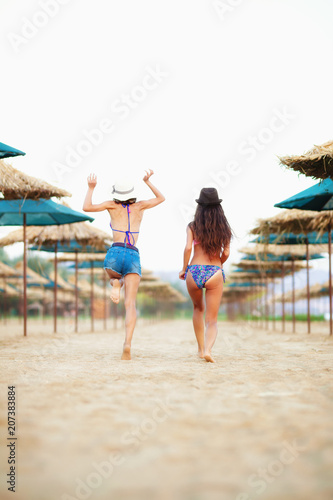 two sexy girls having fun on a beach