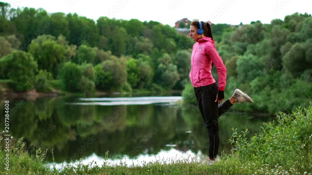The girl warms up early in the morning before training preparing for a run in the sun The girl warms up early in the morning before training preparing for a run in the sun