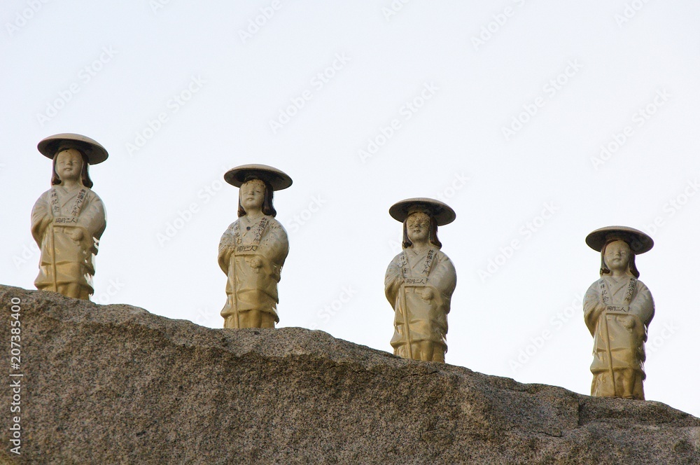 Four stone statues