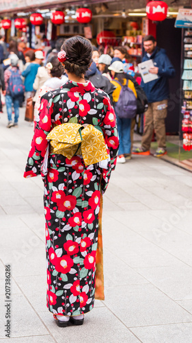 TOKYO, JAPAN - OCTOBER 31, 2017: The girl in a kimono on a city street. Back view. Vertical.