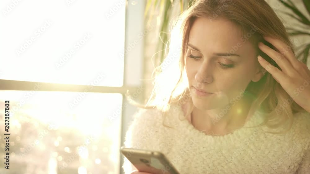 Unhappy woman texting message on mobile. Close up of sad woman looking mobile. Sadness girl texting sms. Negative female emotion. Annoyed woman with smartphone. Stress concept