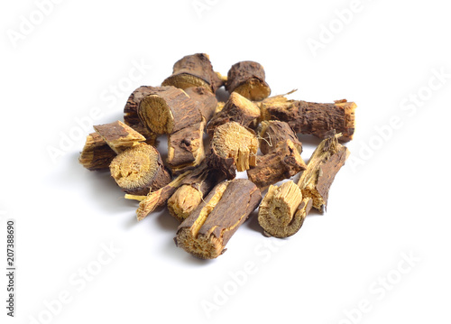 Dried medicinal herbs raw materials isolated on white. Root of Glycyrrhiza.