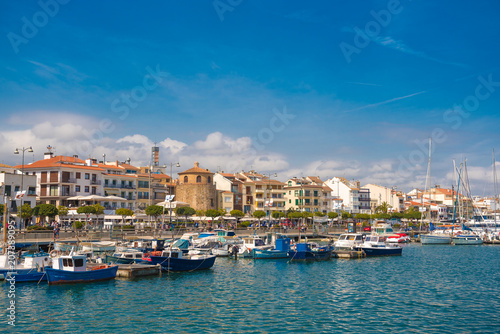 CAMBRILS, SPAIN - APRIL 30, 2017: View of port and city waterfront with Church Of Saint Peter in middle and Torre del Port. Copy space for text. © ggfoto