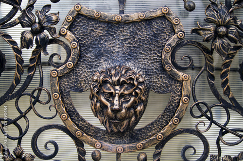Forged gate with the image of a lion's head