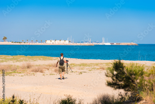 MIAMI PLATJA, SPAIN - APRIL 24, 2017: Photographer on the beach. Copy space for text.