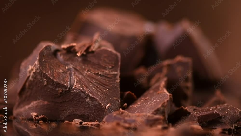 Chocolate. Chunks of sweet dark chocolate rotated closeup. Dessert ingredient. Confectionery. Slow motion 4K UHD video 3840X2160 Chocolate. Chunks of sweet dark chocolate rotated closeup. Dessert ingredient. Confectionery. Slow motion 4K UHD video 3840X2160
