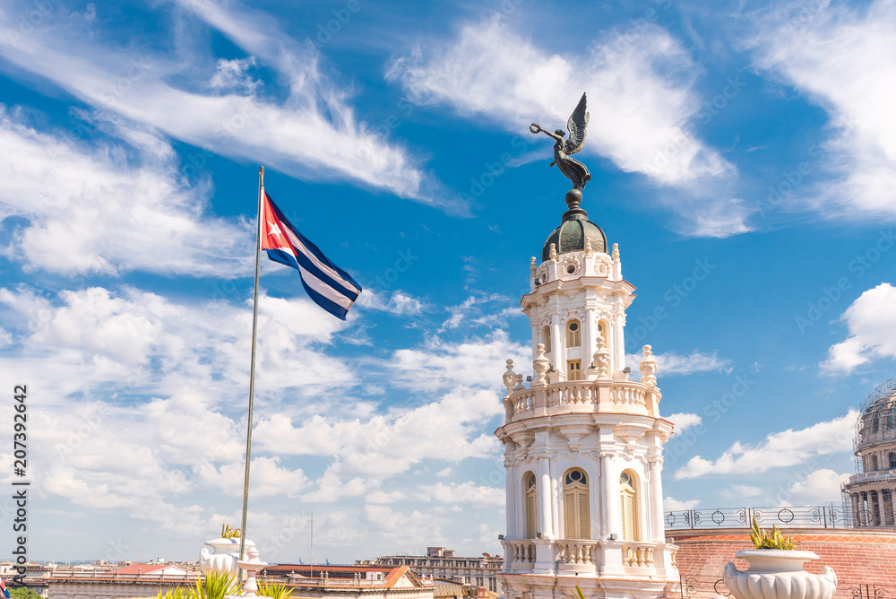 Fototapeta premium CUBA, HAVANA - MAY 5, 2017: The building of the Havana grand theater. Cuban flag. Copy space for text.