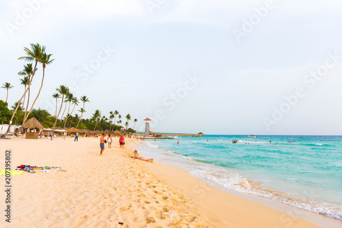 Fototapeta Naklejka Na Ścianę i Meble -  BAYAHIBE, DOMINICAN REPUBLIC - MAY 21, 2017: Sand beach. Copy space for text.