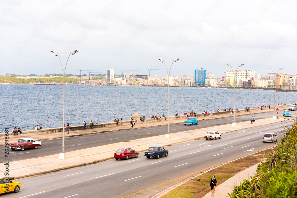 CUBA, HAVANA - MAY 5, 2017: Cars drive along the Malecon waterfront. Copy space for text.