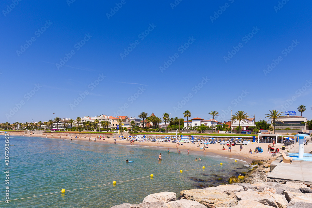 SITGES, CATALUNYA, SPAIN - JUNE 20, 2017: View of the sandy beach and promenade. Copy space for text.