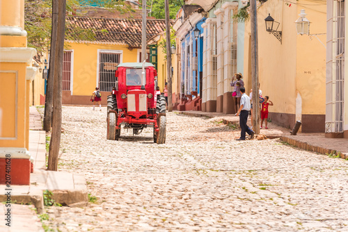 Photography TRINIDAD, CUBA - MAY 16, 2017: Red tractor on a city street