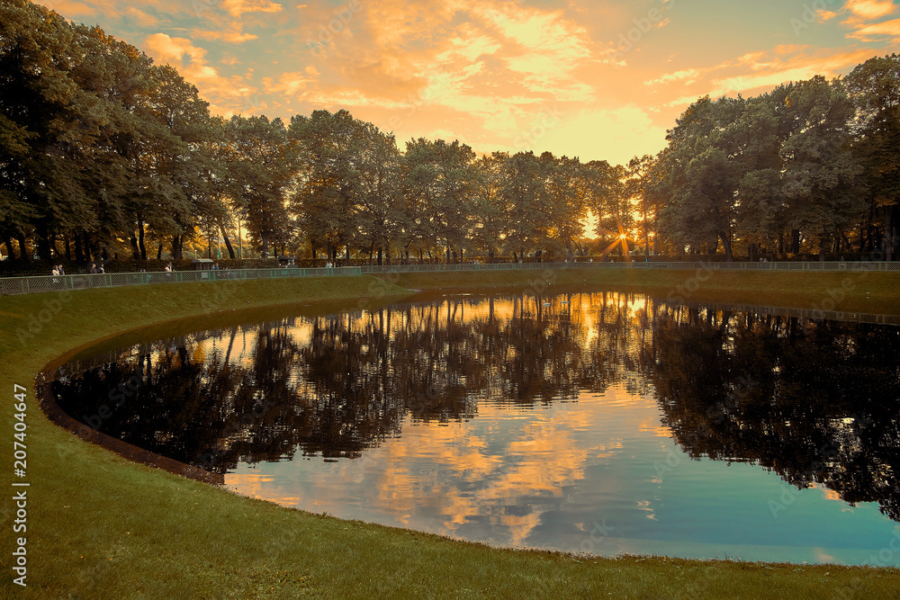 Beautiful sunset on Karpeev pond lake in the Summer garden in Saint Petersburg Russia.