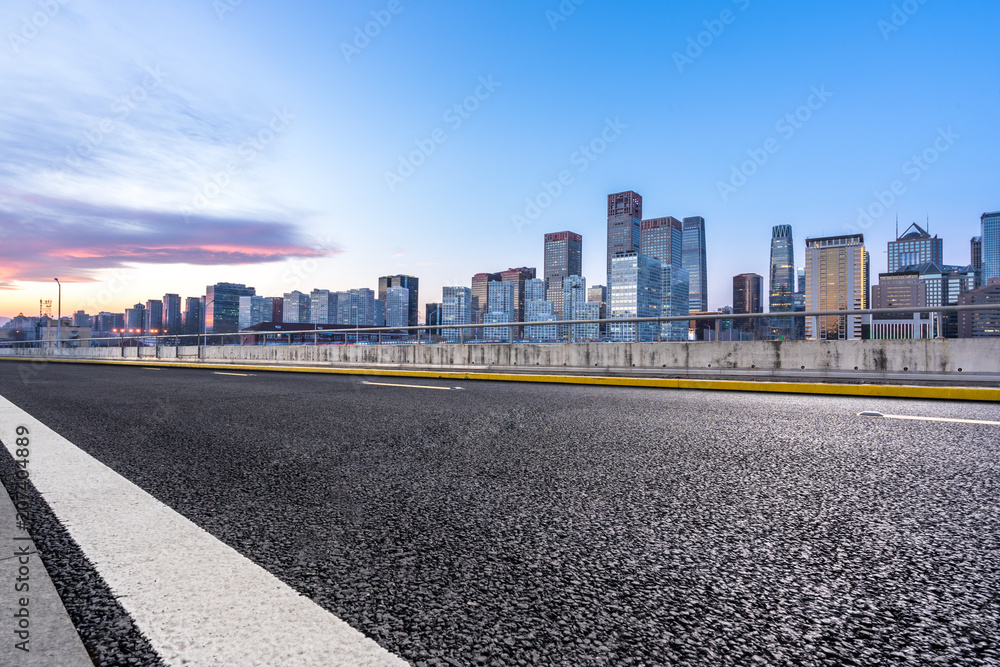 city skyline with asphalt road