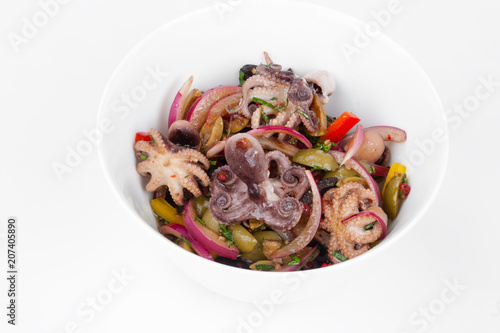 Salad with octopus on a white plate