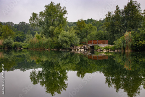 small bridge over a stream with reflection in the water