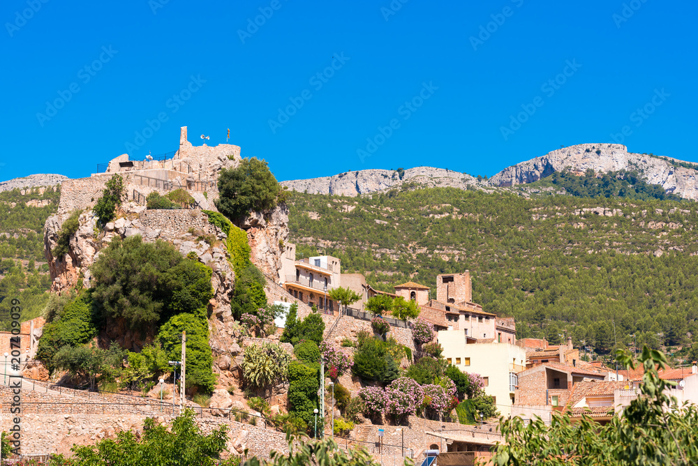 The mountain town of Pratdip in Spain. Copy space for text. Isolated on blue background.