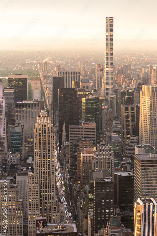 Fototapeta premium New York City skyline with Manhattan urban skyscrapers at dramatic after the storm sunset over famous 5th avenue, USA.