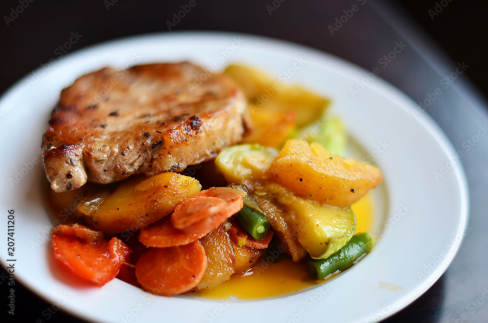tasty meat with potatoes and vegetables on a white plate macro