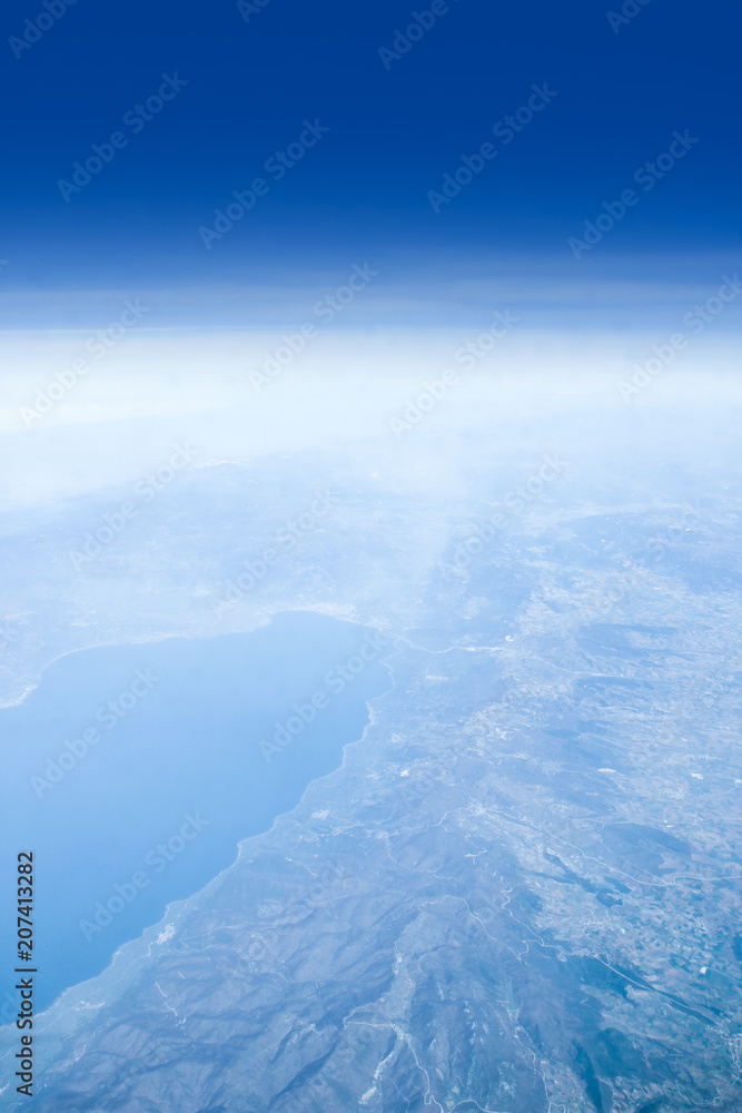 Naklejka premium Beautiful earth and sea from a window airplane background