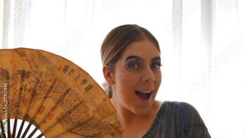 good news  - Cute girl with chinese fan