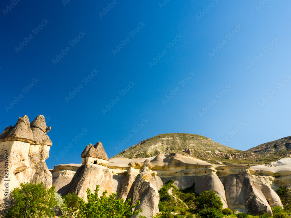 Fototapeta premium Volcanic rock formations with monk cave homes in Pasabag valley central Turkey.