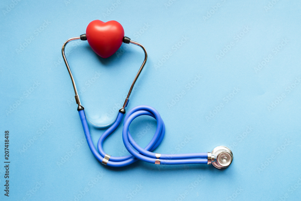 Cardiology, Blue stethoscope with red heart on blue background, heart disease, diagnosis of heart disease Cardiology, Blue stethoscope with red heart on blue background, heart disease, diagnosis of heart disease