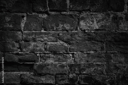 Black weathered crumbled brick wall as background