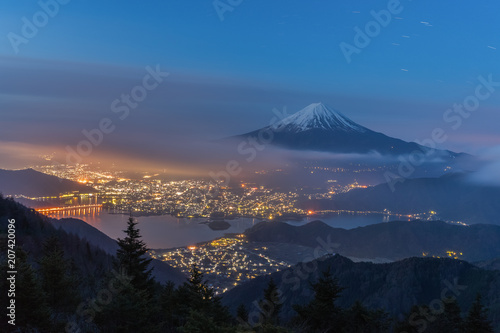 Night landscape of Mountain Fuji with cloudy sky and Kawaguchiko lake seen from Shindo toge view point.