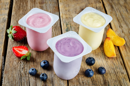 Variation of fruit yoghurts: strawberry, blueberry and peach