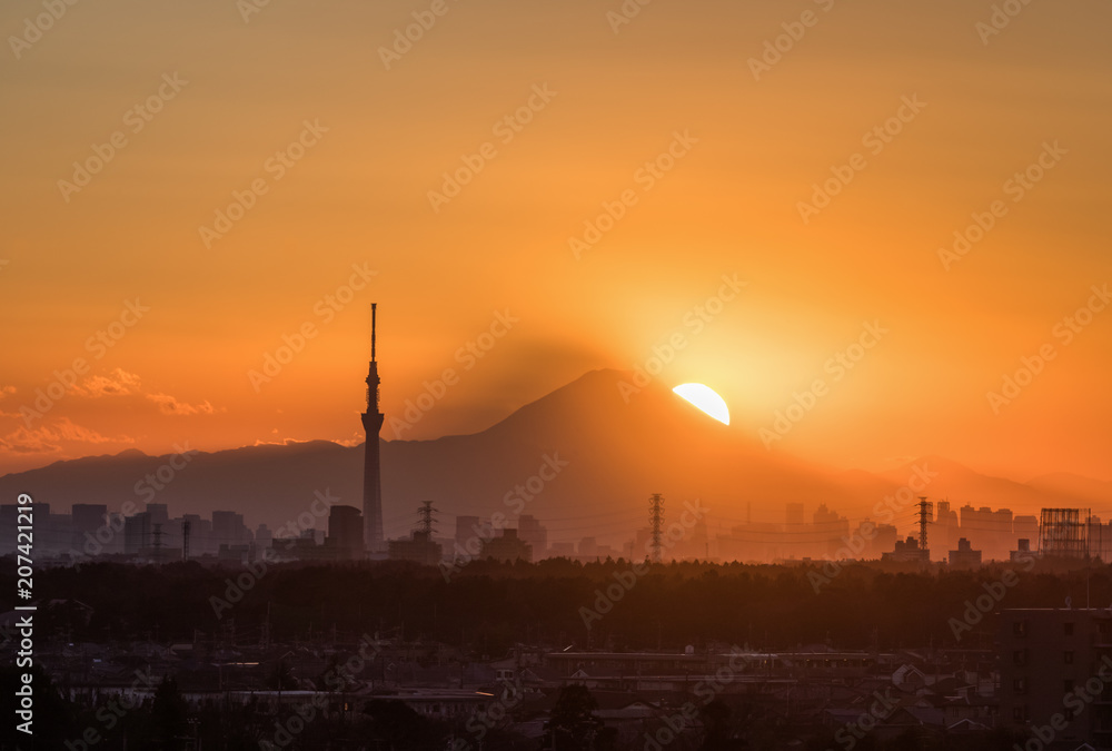 .Tokyo Fuji diamond with Tokyo Skytree landmark.  Diamond Fuji is View of the setting sun meeting the summit of Mt. Fuji