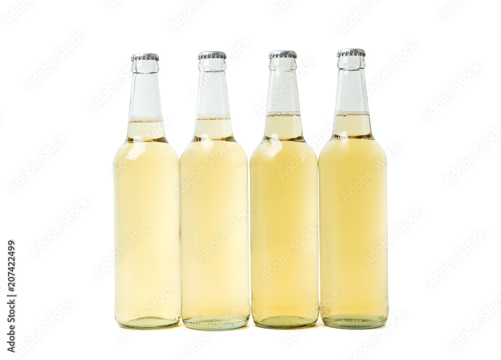 Four yellow bottles of beer on white background. Four yellow bottles of beer on white background.