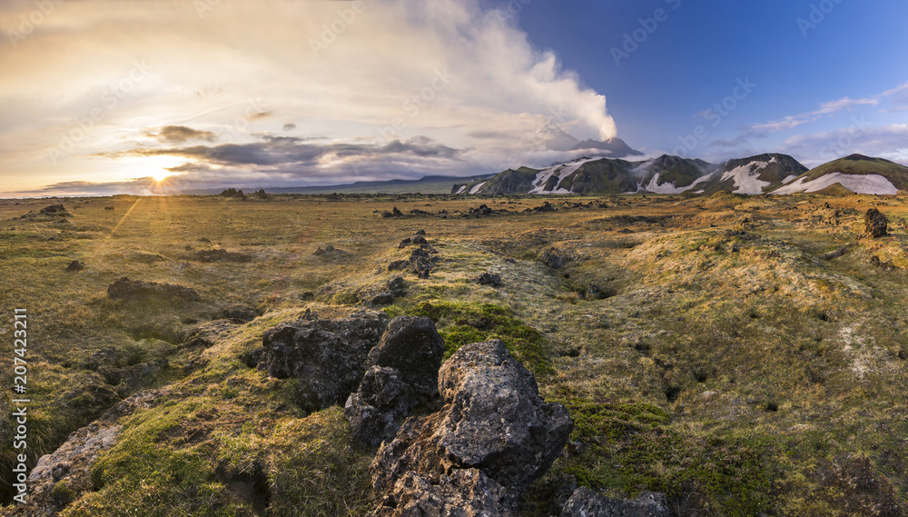 active volcanoes of Kamchatka with snowy hills at sunset active volcanoes of Kamchatka with snowy hills at sunset