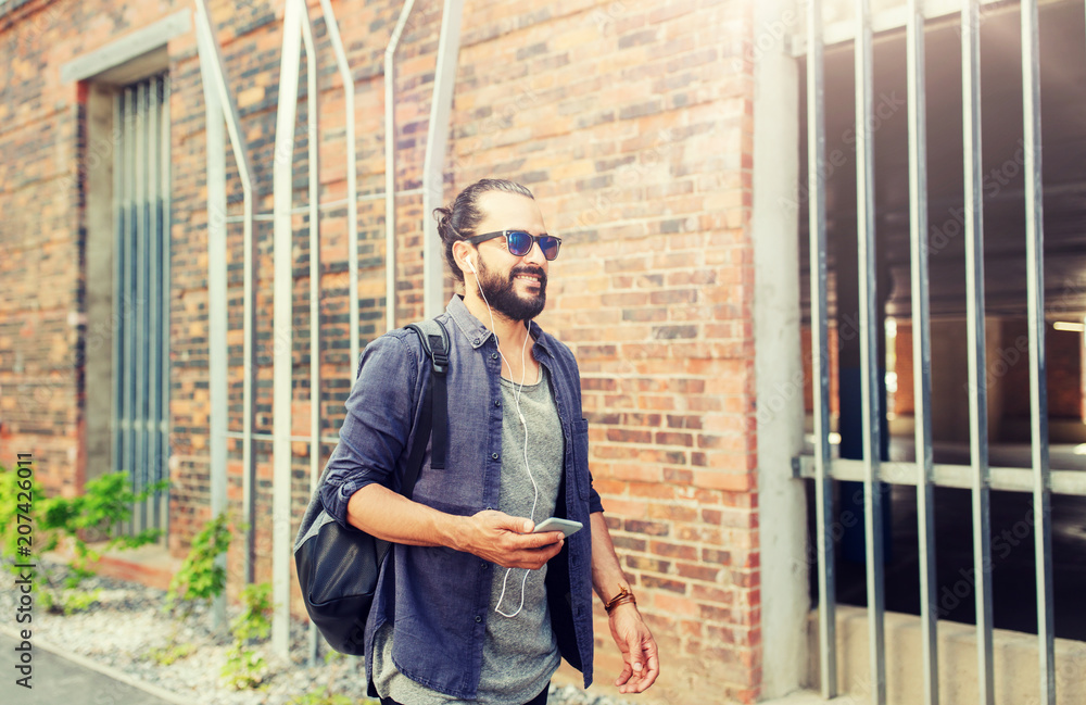 custom made wallpaper toronto digitalpeople, technology, travel and tourism - man with earphones, smartphone and bag walking along city street and listening to music 