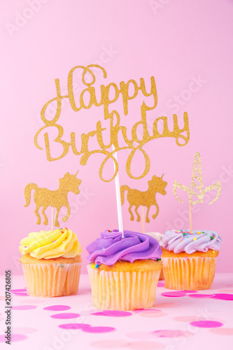 Creative pastel fantasy holiday card with cupcake  happy birthday lettering and unicorn. Baby shower  birthday  celebration concept.