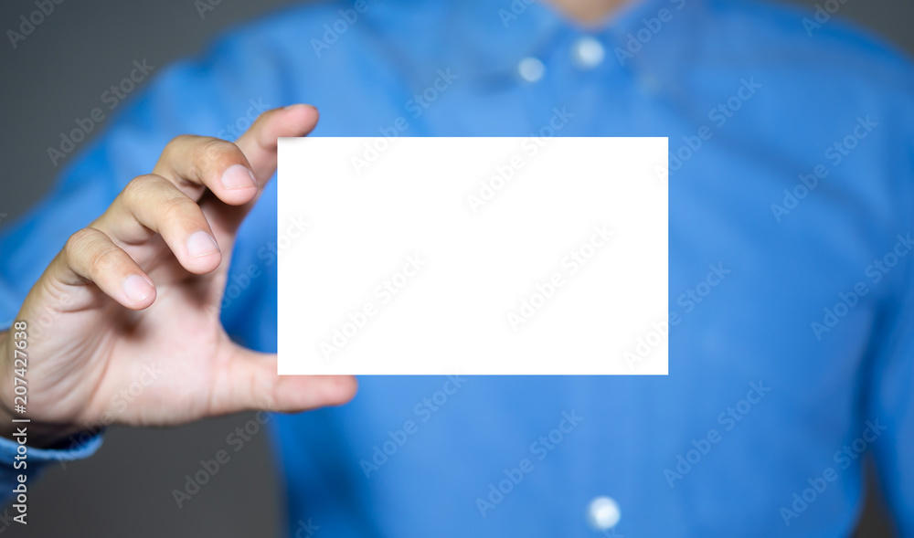 Businessman holding white business card. Businessman holding white business card.