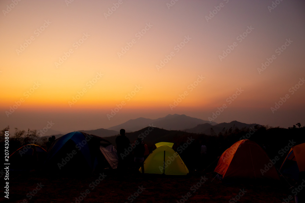 Tourists watch the sunrise on top of the mountain Nern Chang Suek  hills, Kanchanaburi, Thailand