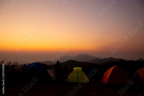 Tourists watch the sunrise on top of the mountain Nern Chang Suek hills, Kanchanaburi, Thailand