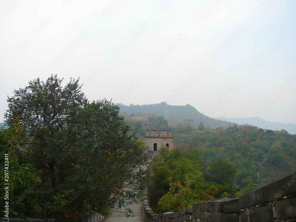 the Great Wall of China; mountains and dense park around