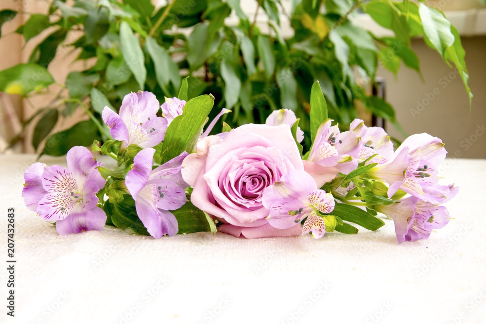 Beautiful bouquet of pink alstroemeria and rose flower on linen cloth Beautiful bouquet of pink alstroemeria and rose flower on linen cloth