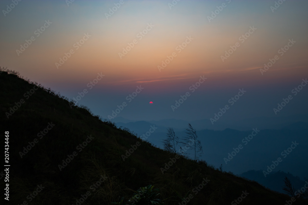 Obraz premium Light sunset behind the mountains Nern Chang Suek hills, Kanchanaburi, Thailand
