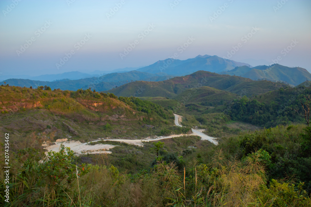 Fototapeta premium Light sunset behind the mountains Nern Chang Suek hills, Kanchanaburi, Thailand