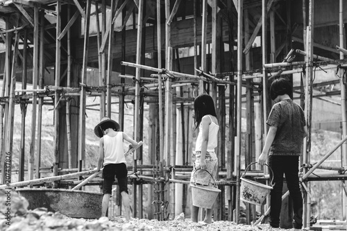 Children working at construction site for world day against children labour concept: