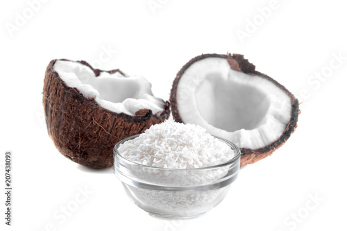 Halves of coconut with coconut shaving on white background isolated