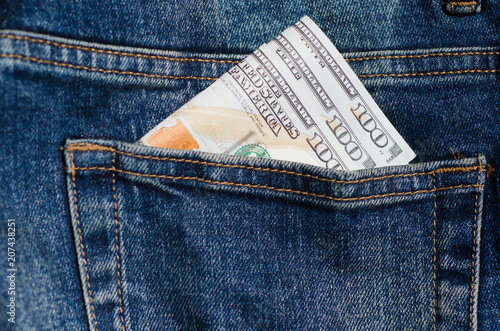 Hundred dollar bill in pocket of blue jeans