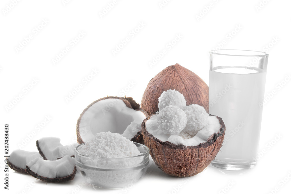 half coconut with coconut sweets, shavings and coconut milk on a white background isolated half coconut with coconut sweets, shavings and coconut milk on a white background isolated