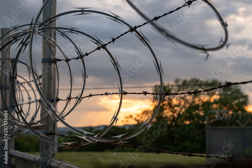 Barbed Wire Fence at Sunset Medium